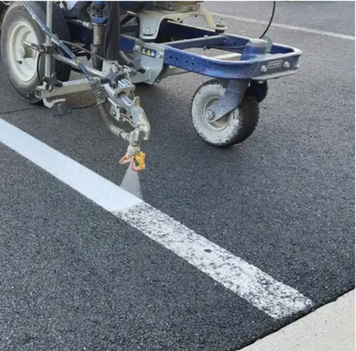 Parking lot restriping after pavement maintenance and sealcoating
